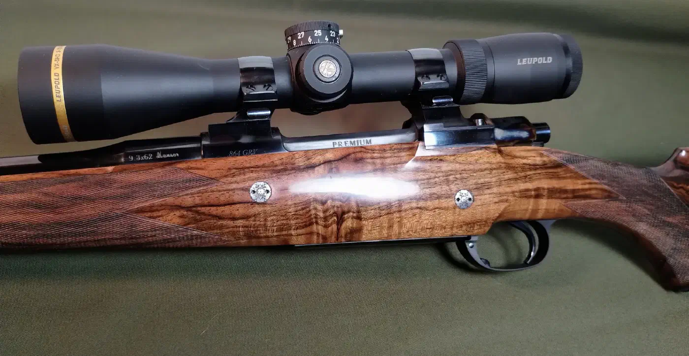 A Premium 9.3×62 custom rifle by Todd Ramirez — Turkish-walnut stock, blued action, mounted Leupold scope.